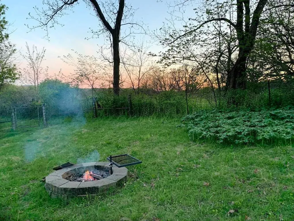 Campfire view from tent deck at sunset