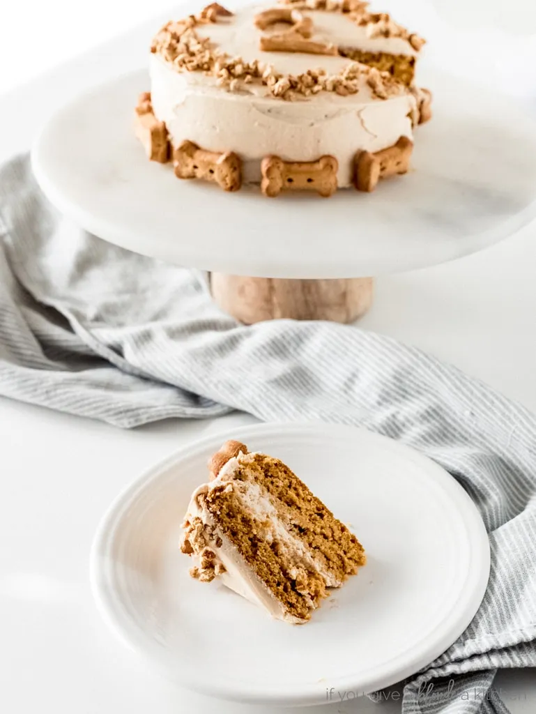 Close-up of a slice of healthy pumpkin dog cake, revealing its moist texture and delicious peanut butter frosting