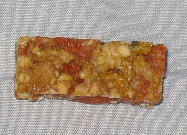 Close-up of a Wild Harvest crunch bar revealing sparse oats and veggie bits