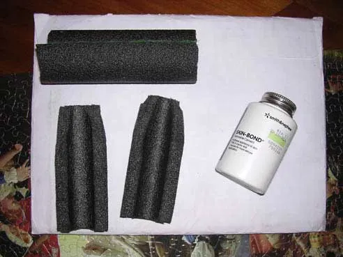 Close-up of materials commonly used for taping German Shepherd puppy ears, including surgical tape and foam rollers