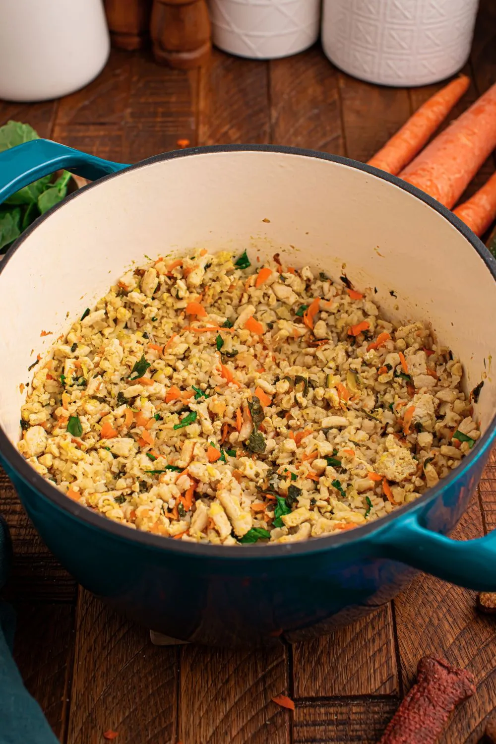Cooked homemade turkey and rice dog food with mixed vegetables, simmering in a pot, emitting a delicious aroma.
