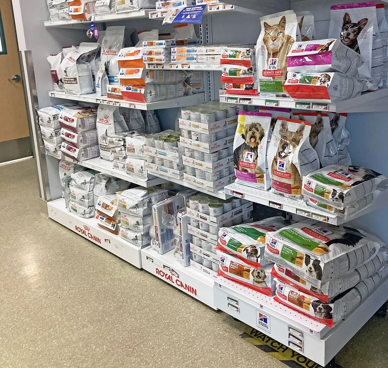 Display of various prescription dog foods, including low-protein options, highlighting their specialized nature for canine health.