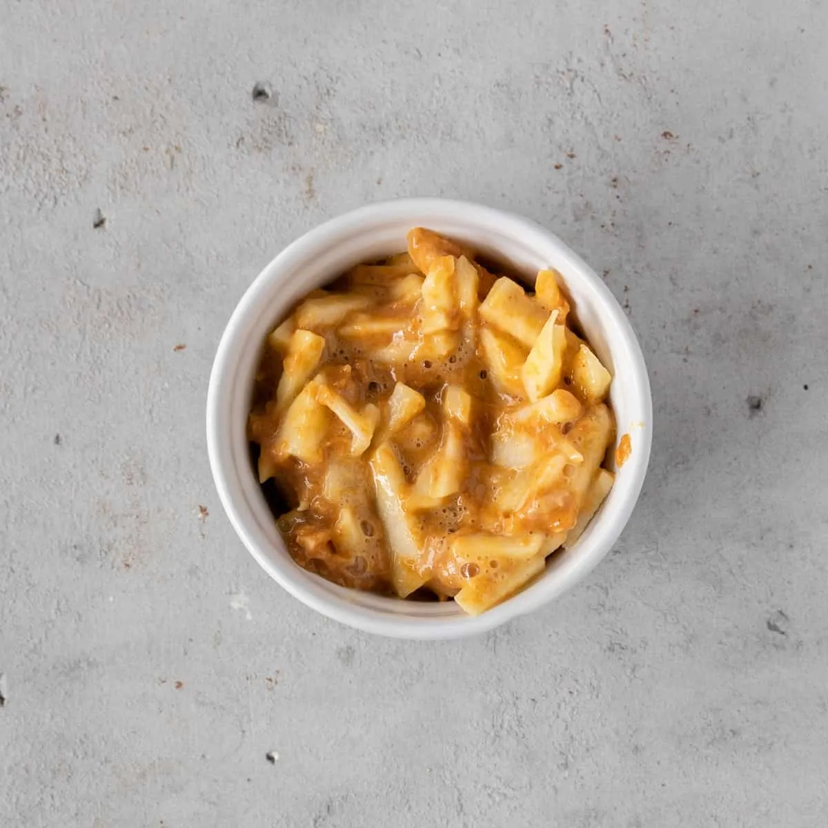 Dog birthday cake batter carefully poured into a small ramekin, ready for baking