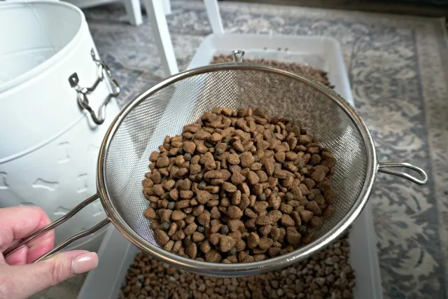 Dog food in a kitchen strainer after being treated with cornstarch