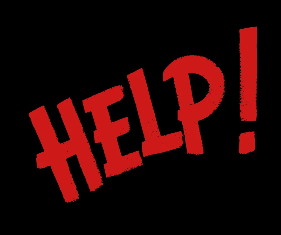 Dog looking stressed in a crate, with paws reaching through the bars.