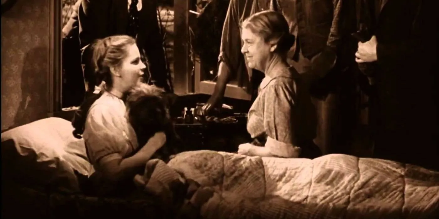 Dorothy, Toto, and Auntie Em in The Wizard of Oz ending