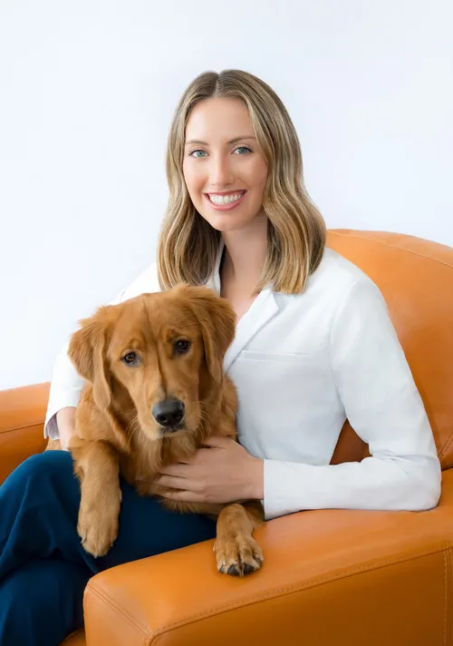 Dr. Alexandra Kukorowski, a skilled veterinarian, smiling in her professional attire
