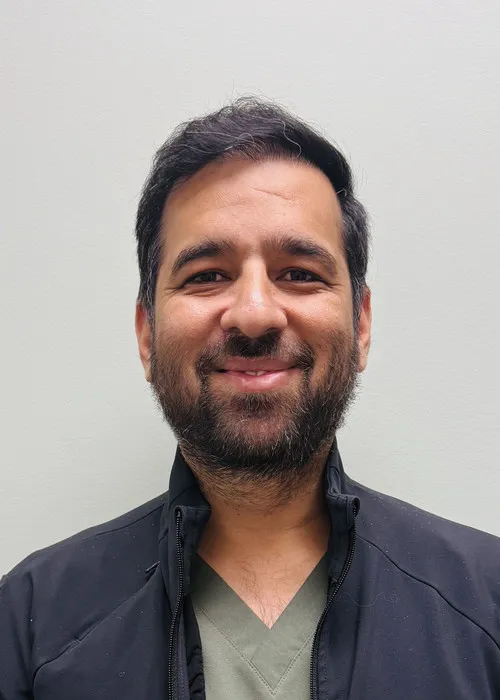 Dr. Arvind Bagga, Lead Veterinarian at Urgent Care Animal Hospital, posing for a professional headshot.