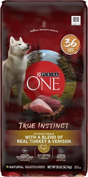 Dry dog food kibble with pieces of turkey and venison, indicating premium ingredients.