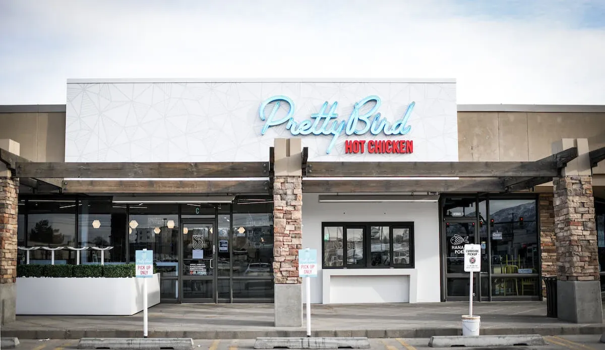 Dynamic kitchen action at Pretty Bird Hot Chicken emphasizing precision and quality