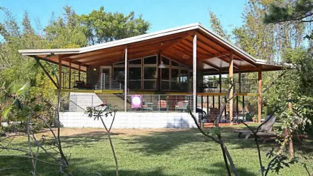 Exterior view of a Bird Cage House with wide overhangs and jalousie windows