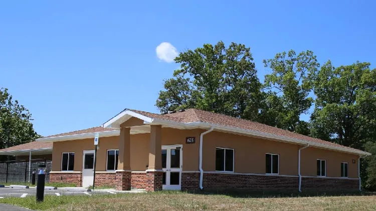 Exterior view of the modern Patriot Pet Care facility with green landscaping and a welcoming entrance