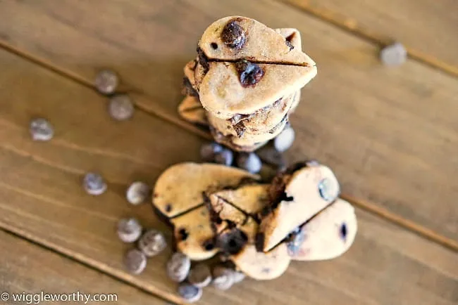 Freshly baked carob chip dog treats arranged on a rustic wooden board