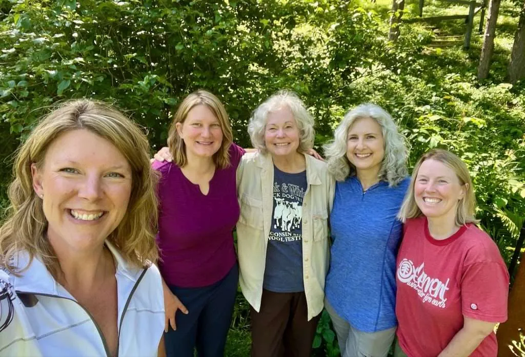 Group of experienced dog trainers gathered at a farm