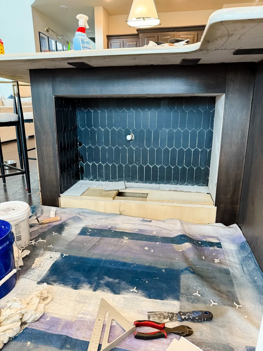 Installing decorative tiles around the built-in dog feeding station for a durable and elegant finish