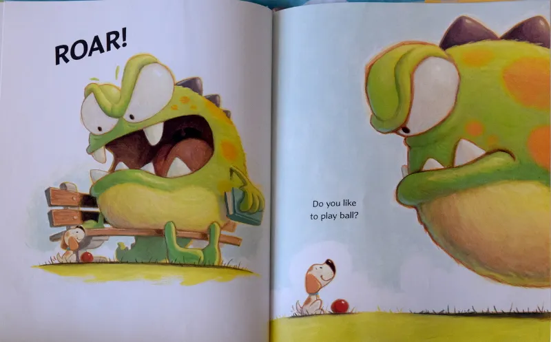 Little Puppy happily playing with the Big Green Monster, a moment of pure joy and companionship