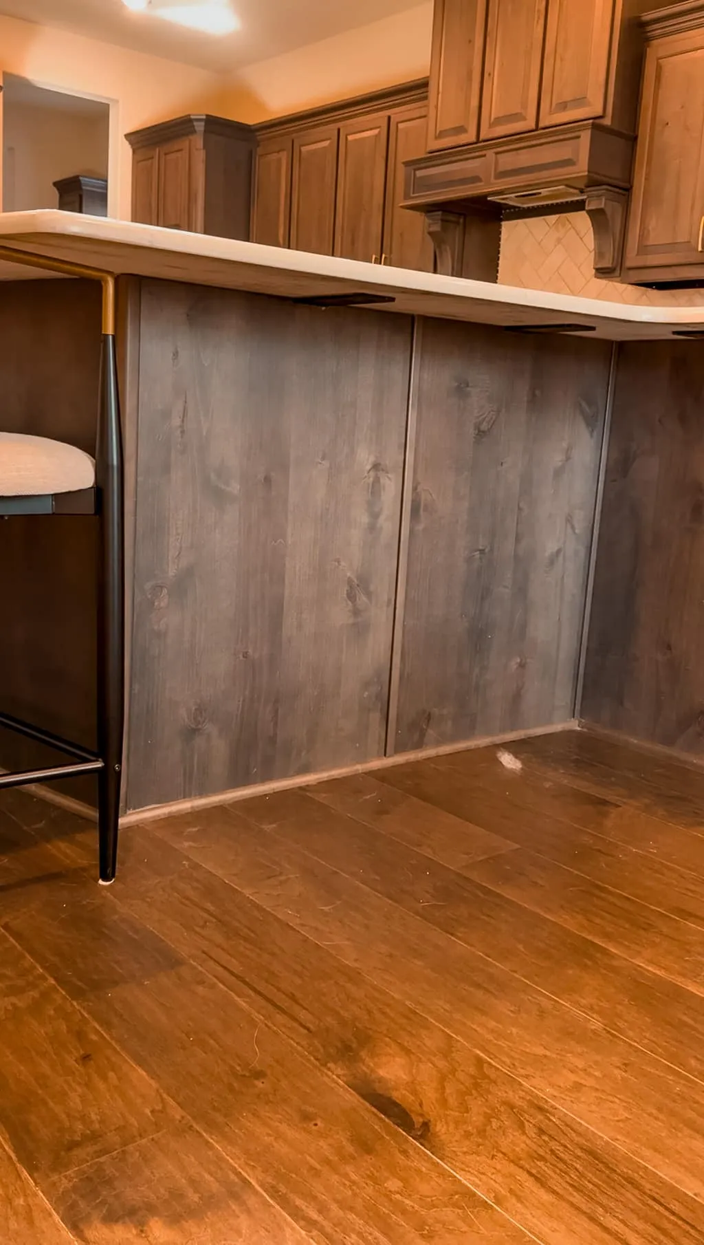 Measuring the side of a kitchen island for precise dimensions of a built-in dog feeding station