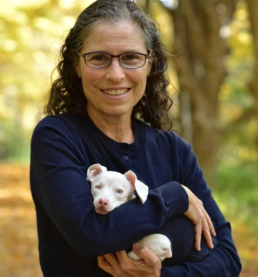 Melissa Shapiro holding Piglet in her arms, both smiling during a book signing event.