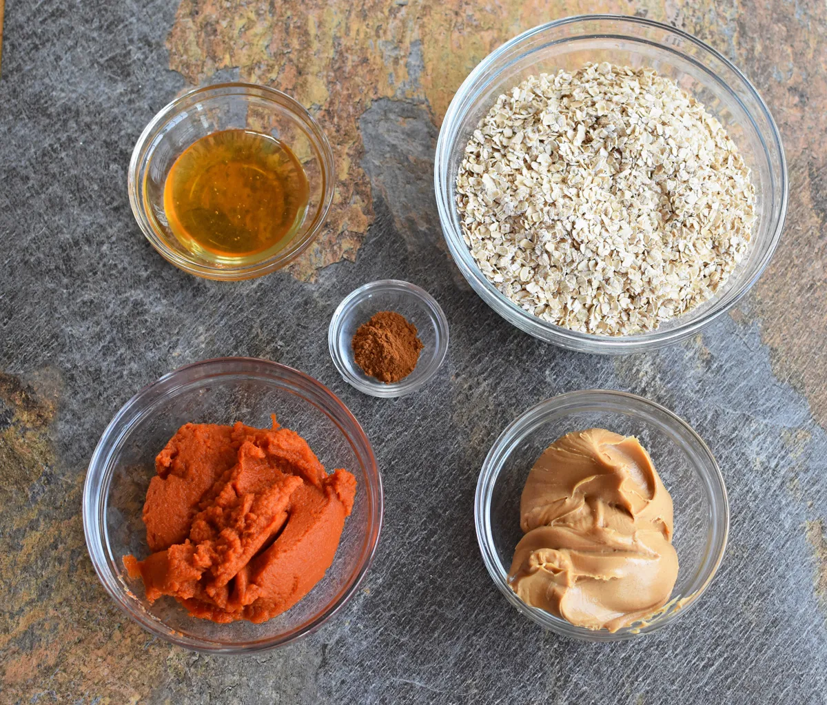 Pumpkin Dog Treats Ingredients on a stone surface.