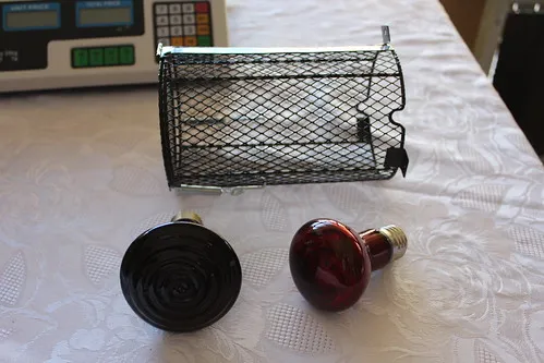 Red heat globes and protective black mesh cage to prevent burns
