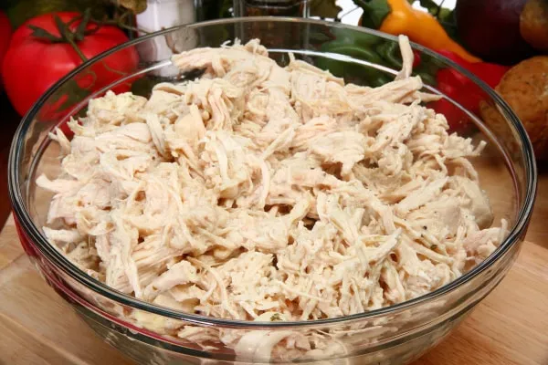 Shredded plain cooked chicken, a lean and appealing option for hiding pills