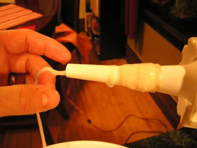 Sliding sheep intestines onto the sausage stuffer nozzle