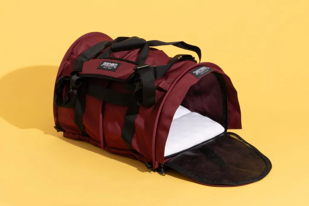 SturdiBag Pro 2.0, a highly-rated pet travel carrier, on a bright yellow background.