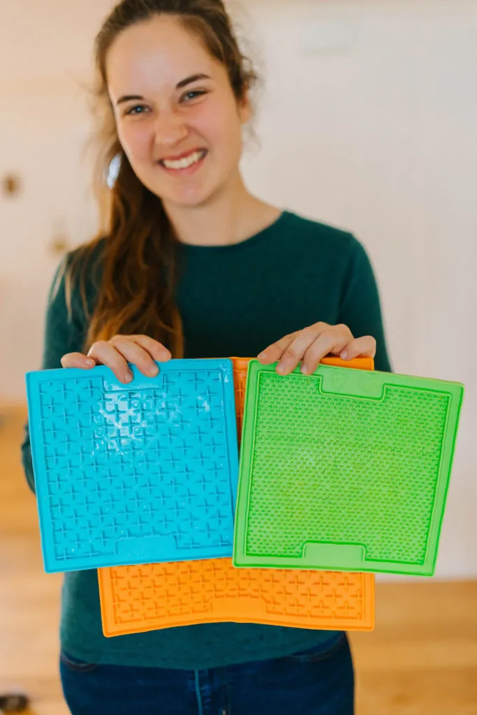 Three different Lickimats filled with healthy dog treats