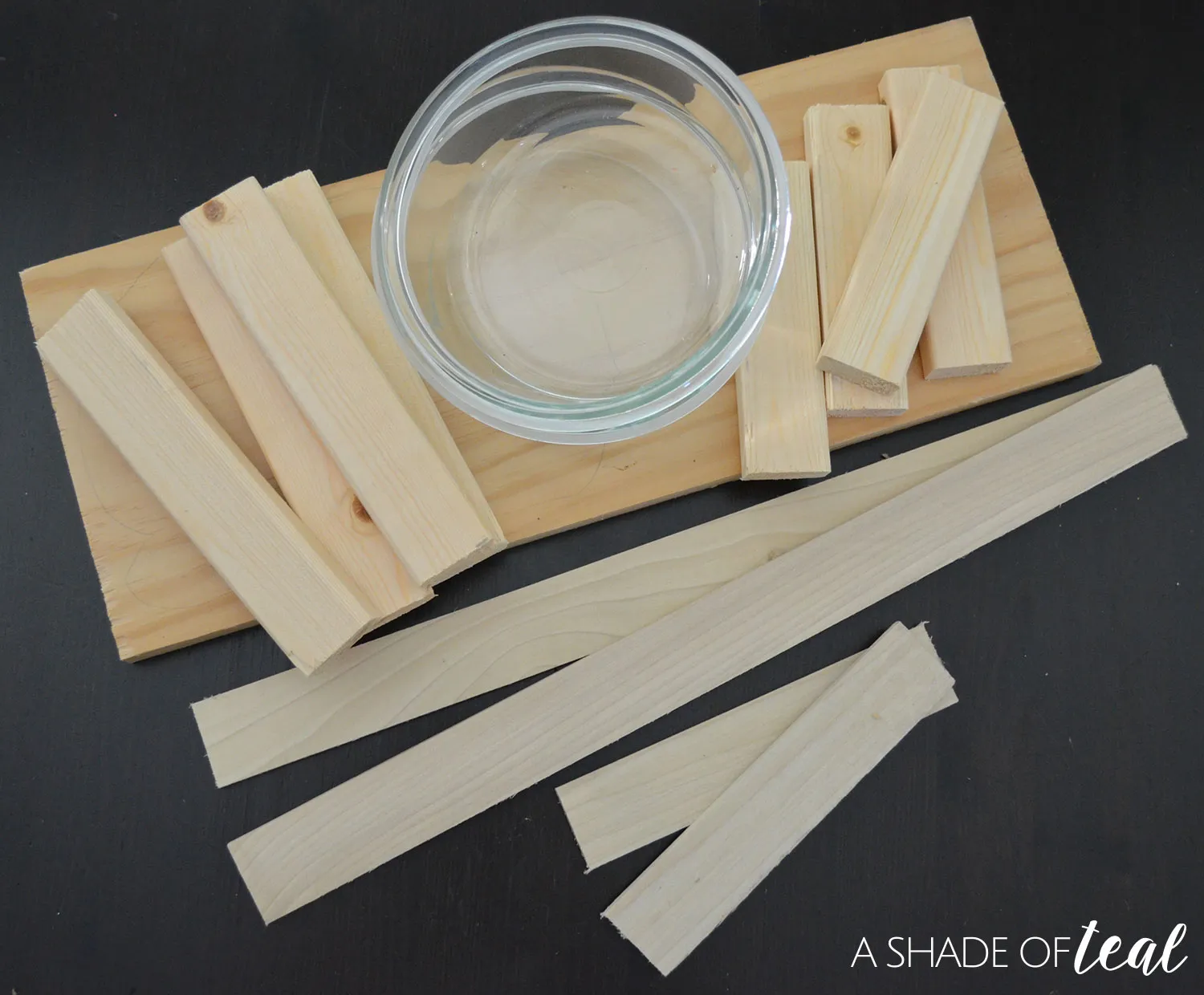 Tracing the dog bowls onto the wooden board as a first step in DIY construction