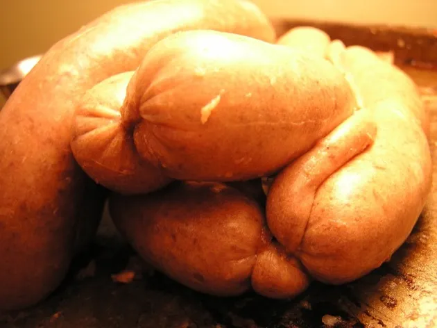 Twisting stuffed casings into individual hot dog portions
