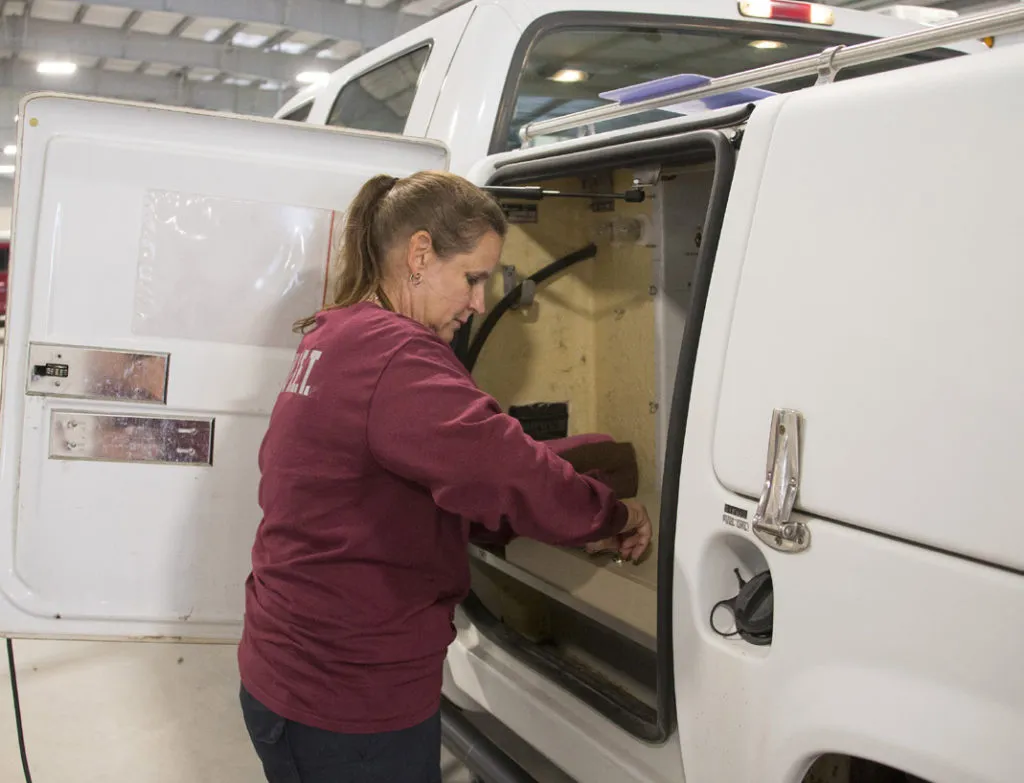 Vet team members working with a support van at a disaster site