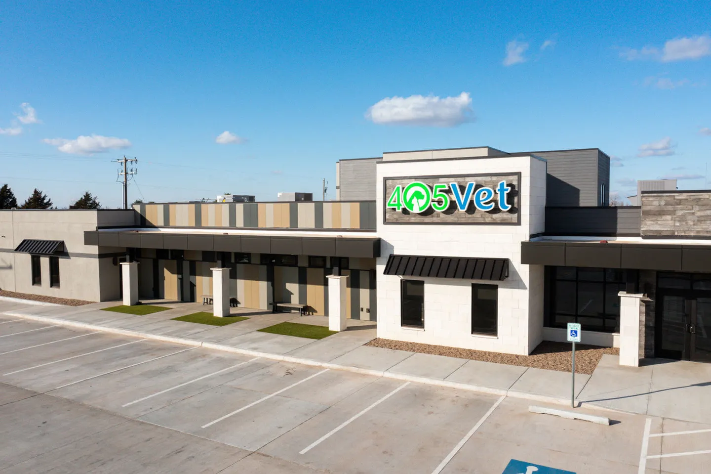 Veterinary staff warmly greeting a pet owner and their dog in a modern clinic reception area