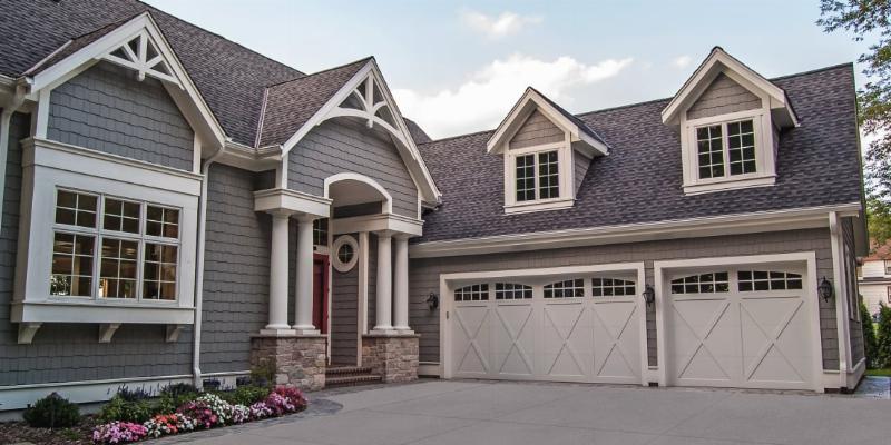 An artist in a workshop meticulously applying color to a large, curved fiberglass section of a massive sculpture.