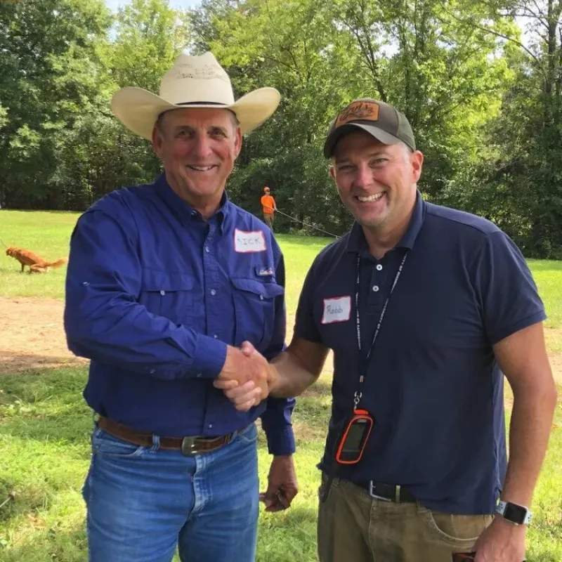 alt-text: Young bird dog puppy enthusiastically learning scent work in a grassy field, Missouri, USA