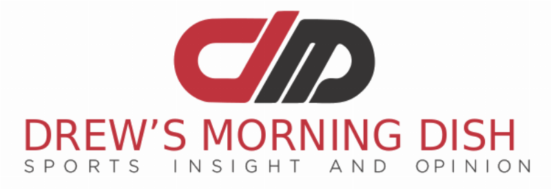 An action shot of the Dave and Busters horse racing game, Derby Owners Club, showing multiple players seated at their terminals, intently focused on the large central screen displaying the race.