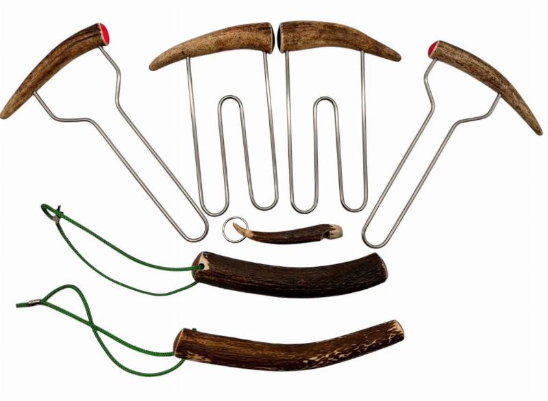 Essential deer tracking dog training equipment laid out on a rustic wooden background, including a tracking harness, a long lead, a bottle of deer scent, and high-value treats.