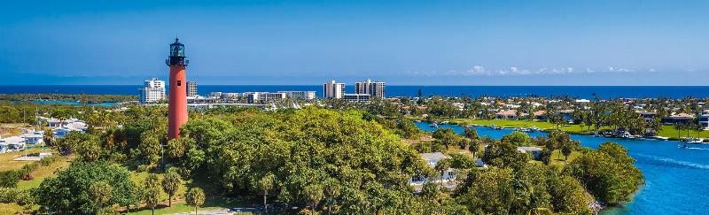 Obedient dog responding to owner’s command in a park in Boca Raton
