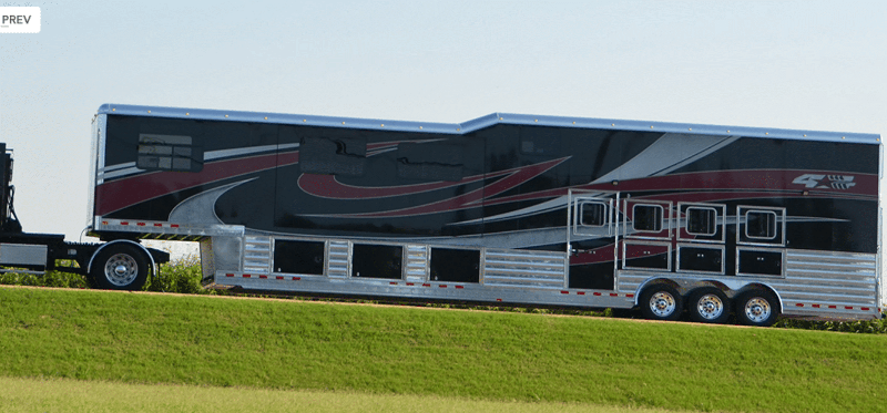 A large commercial double-decker 2 story horse trailer on a highway, designed for hauling multiple horses.