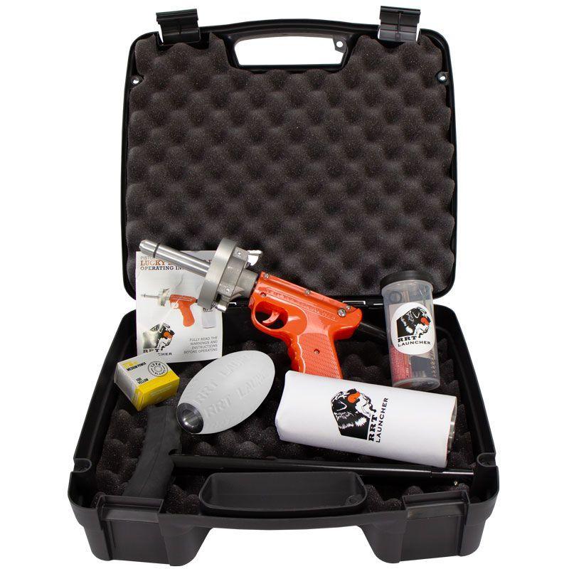 A collection of various gun dog training products including canvas dummies, plastic bumpers, and a whistle on a wooden surface