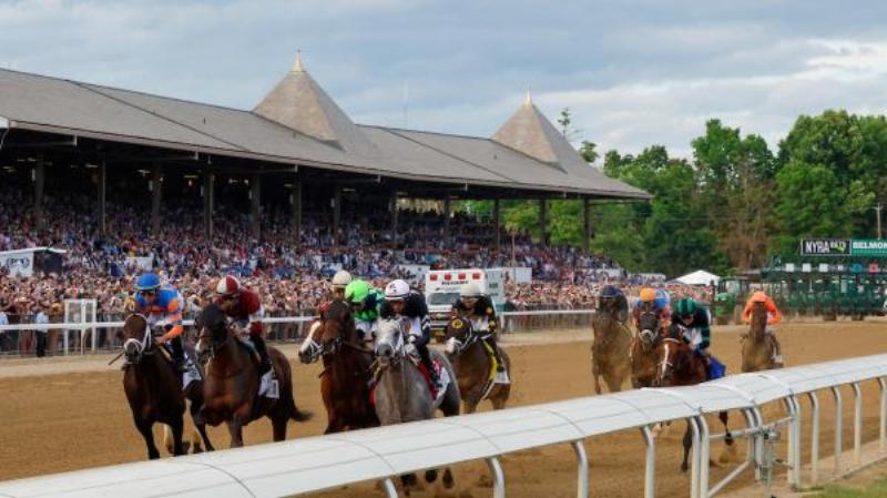 The historic grandstand at Saratoga Race Course, the oldest horse racing track in America for thoroughbreds, bustling with spectators.