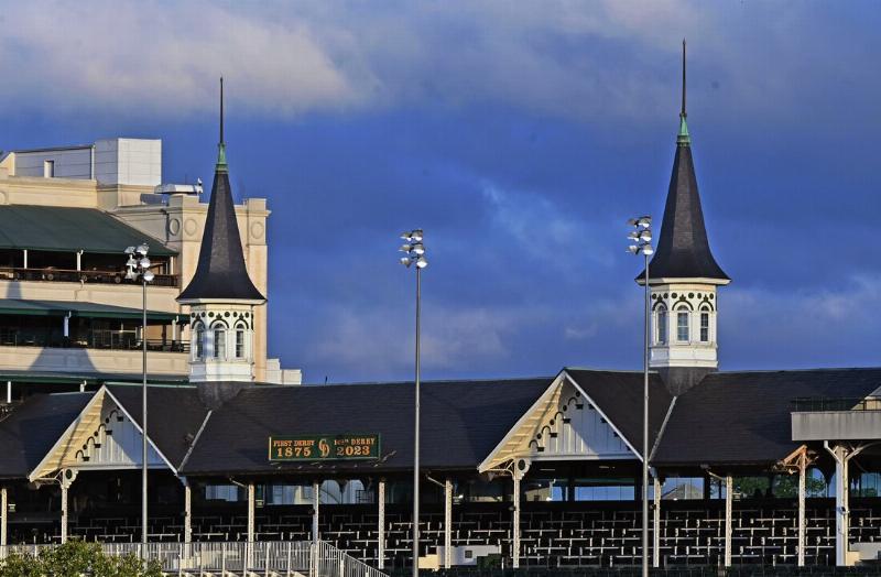 A close-up of a betting slip for a box bet in horse racing held by a person at the track