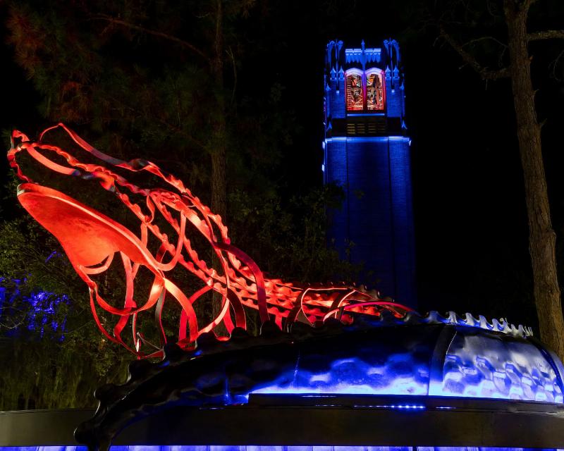 A close-up of a Corky Randall horse trainer figure gently touching the muzzle of a horse, symbolizing trust and communication.