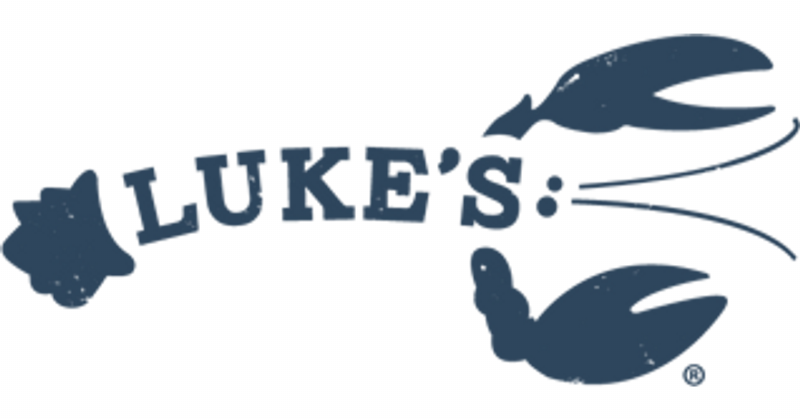 Restaurateur Jeff Ruby smiling at a horse racing track, wearing a fine suit and holding a trophy.