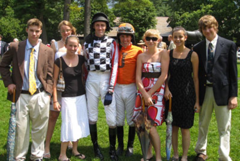 An insightful portrait of legendary horse trainer Jonathan Shepherd observing a powerful thoroughbred during a morning workout at the track