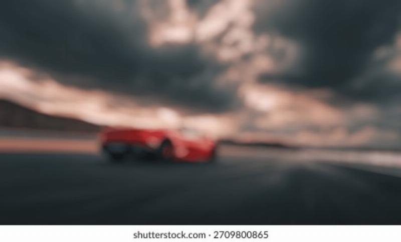 A panoramic view of the iconic Meydan Racecourse in Dubai, with thoroughbreds racing on the turf track during an evening event under the bright lights.