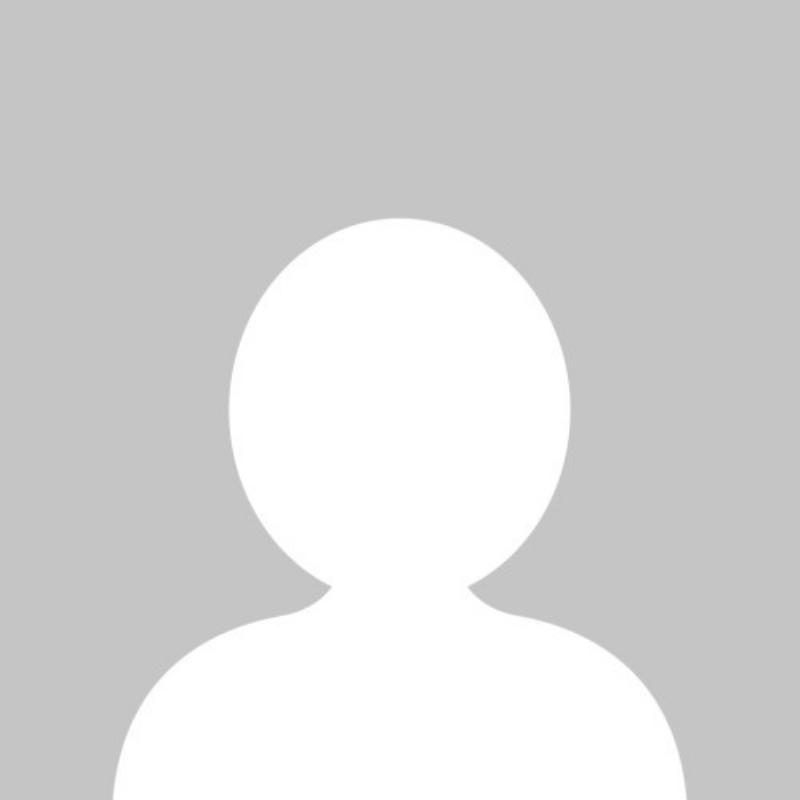 A woman and her happy golden retriever practicing positive reinforcement training with a clicker in a bright, modern living room, representing the evolution beyond the Caesar the dog trainer era