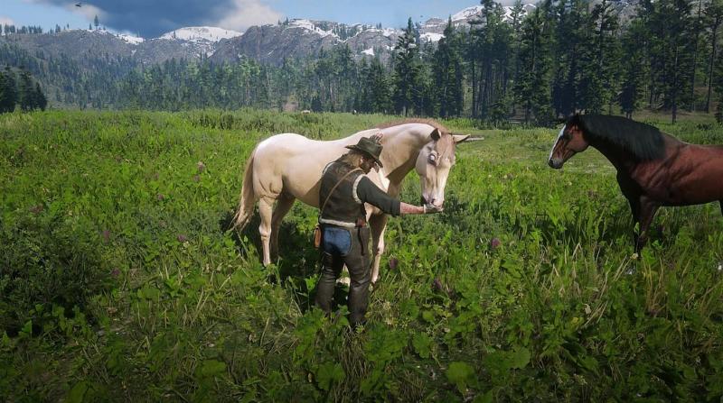 Arthur Morgan patting his main horse in the wilderness of Red Dead Redemption 2, showcasing the bond between player and horse when discussing if you can own multiple horses.