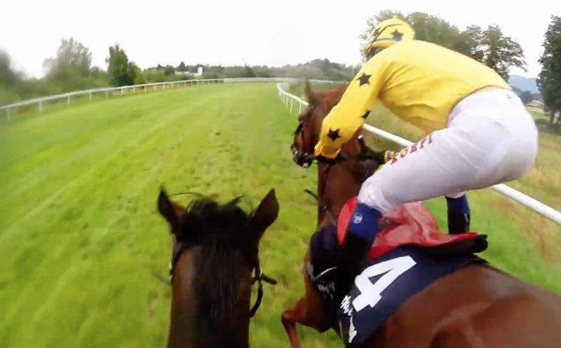 Two racehorses and their jockeys neck-and-neck at the finish line, dirt flying, showcasing the peak of athletic partnership and competition.