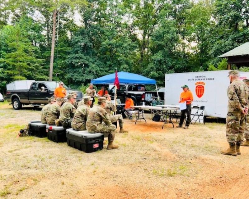 A SAR dog and handler team work together during a wilderness training exercise.