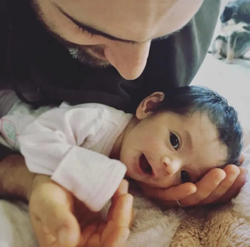A touching image depicting a close bond between a person and their service dog, perhaps resting together or engaging in a calm interaction, symbolizing emotional connection.